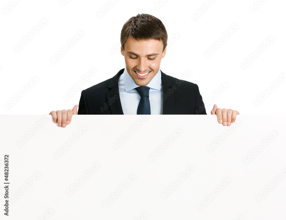 Happy businessman showing signboard, isolated Happy businessman showing signboard, isolated