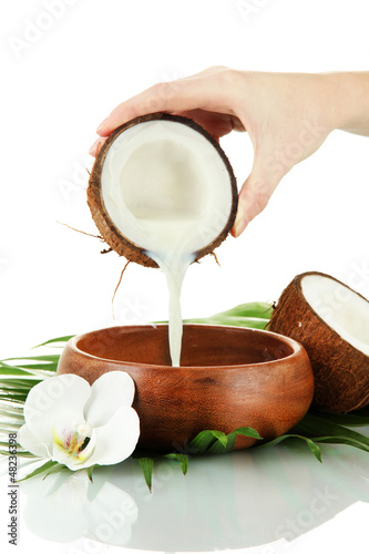 Coconut with coconut milk and leaves, isolated on white