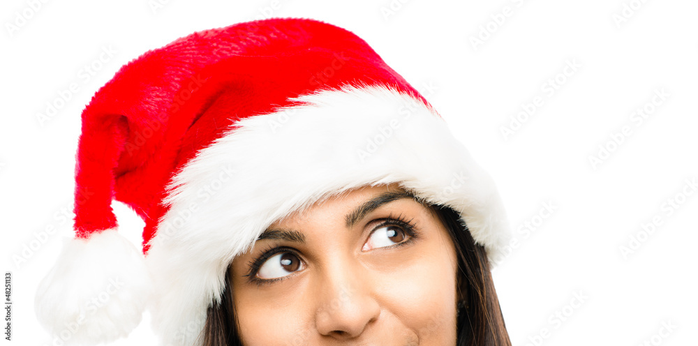 Close up of pretty woman wearing christmas hat looking up isolat Close up of pretty woman wearing christmas hat looking up isolat