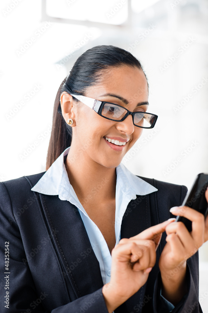 Indian business woman using mobile phone happy