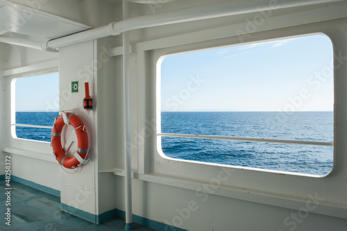 Ship windows with a relaxing seascape and blue sky view.