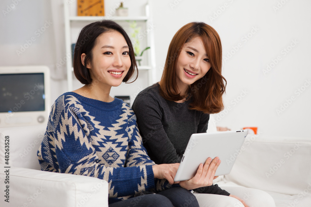 Two Asian young woman using tablet PC. Two Asian young woman using tablet PC.