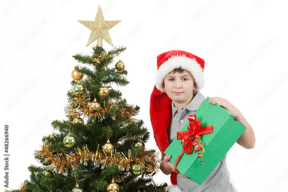 happy boy in santa hat show christmas present