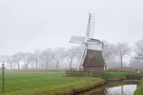 Dutch windmill in fog © Olha Rohulya