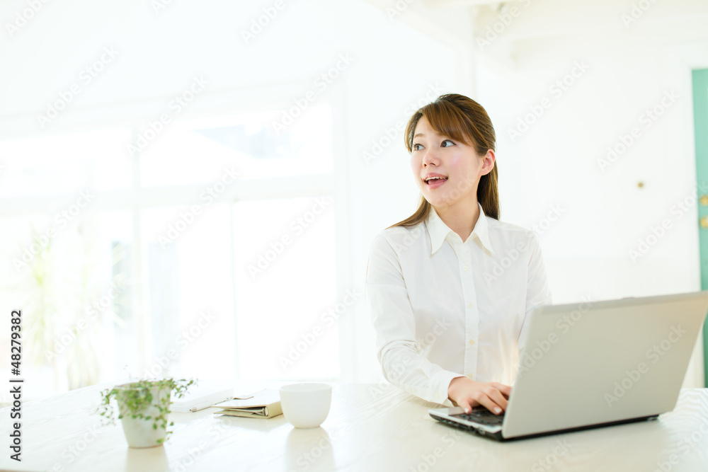 Beautiful asian businesswoman using a laptop computer