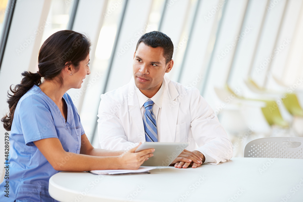 Doctor And Nurse Having Informal Meeting In Hospital Canteen Doctor And Nurse Having Informal Meeting In Hospital Canteen