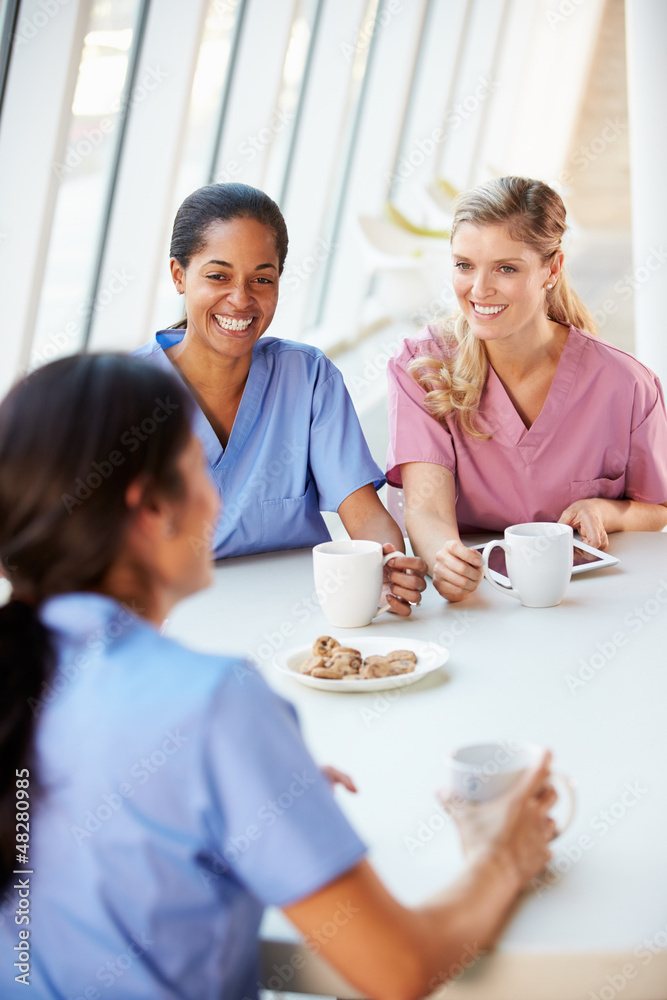 Group Of Nurses Chatting In Modern Hospital Canteen Group Of Nurses Chatting In Modern Hospital Canteen