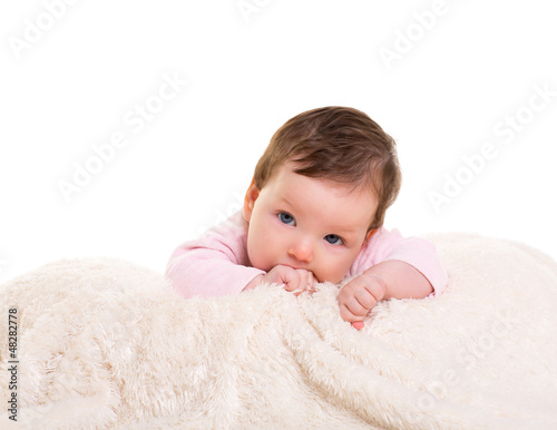 baby girl with toothache in pink with on white fur