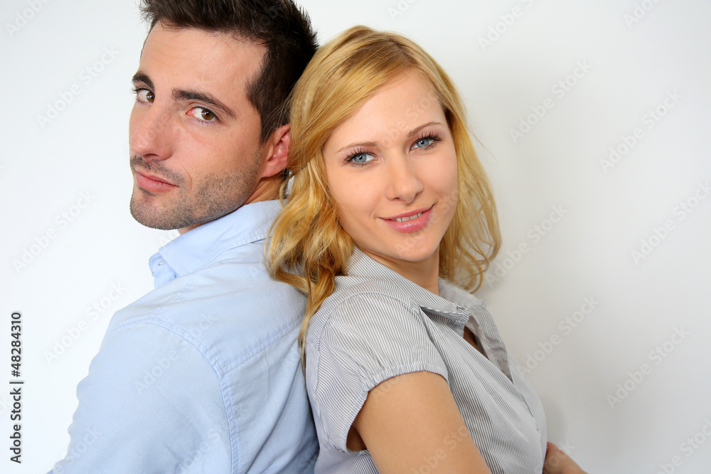 Couple standing back to back on white background Couple standing back to back on white background