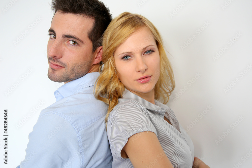 Couple standing back to back on white background Couple standing back to back on white background