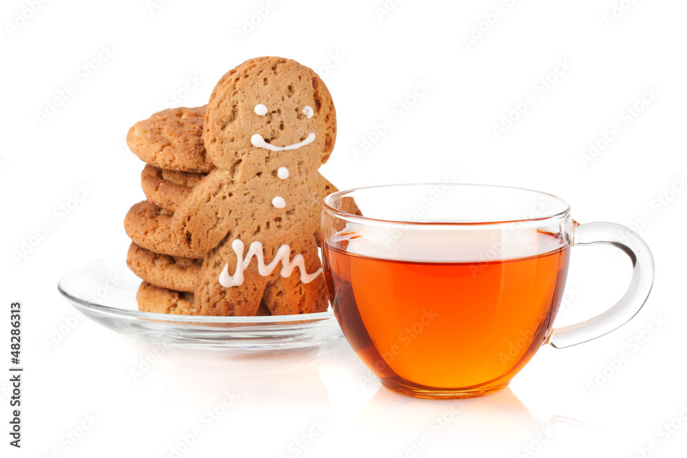 Glass cup of black tea with homemade cookies and gingerbread man Glass cup of black tea with homemade cookies and gingerbread man