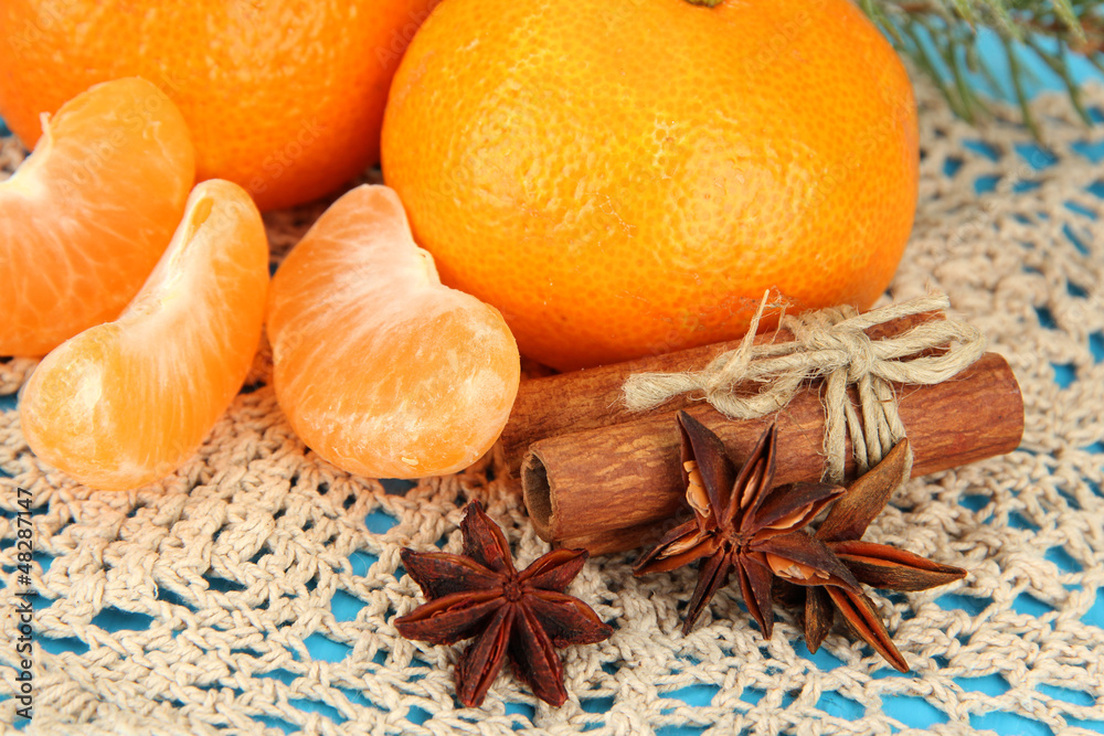 Tasty mandarines on napkin on blue background Tasty mandarines on napkin on blue background