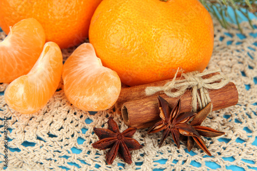Fototapeta Naklejka Na Ścianę i Meble -  Tasty mandarines on napkin on blue background