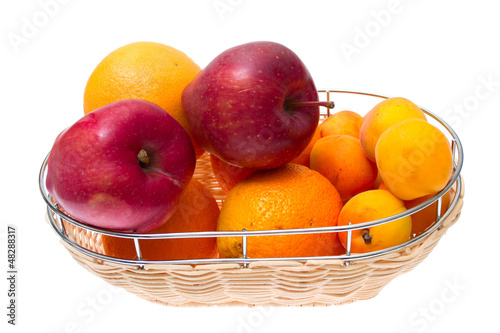 Apple, orange, apricot on bowl isolated on white background