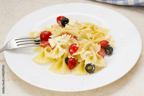 Pasta ribbons, cherry tomatoes and olives