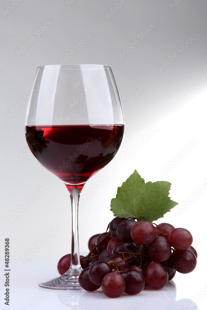 glass of wine and grapes, isolated on white