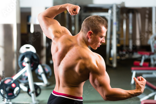 Bodybuilder posing in Gym