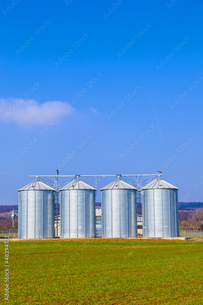 Fototapeta premium silver silos in field