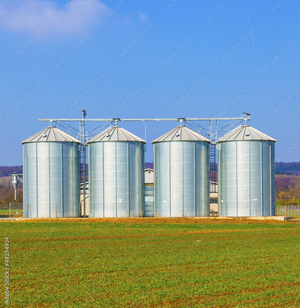 silver silos in field silver silos in field
