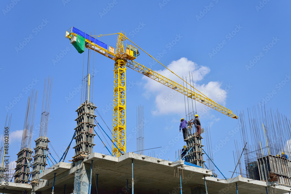 Construction site with crane and workers Construction site with crane and workers