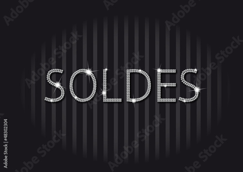 Soldes en strass et diamants brillants sur fond noir rayé