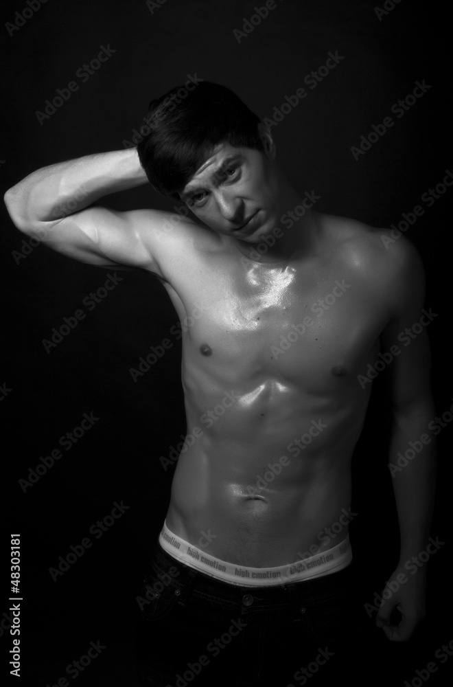 Studio shot of strong fitness handsome sports man thinking, look