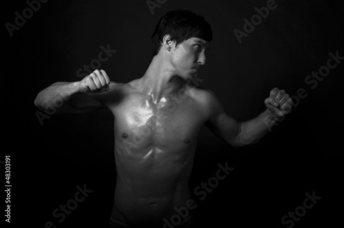 Studio shot of strong fitness handsome sports man fighting