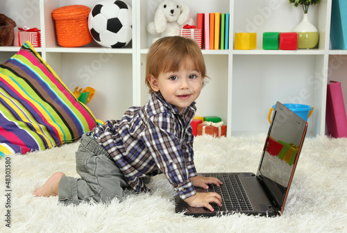 cute little boy and noteboo...
