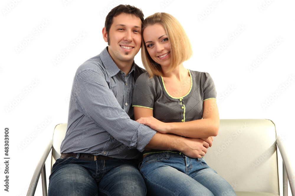 Young couple sitting together isolated on white Young couple sitting together isolated on white