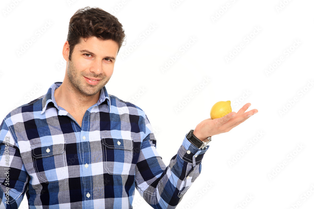young man holding a lemon young man holding a lemon