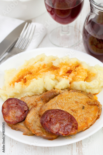meat with chorizo and potato on the plate