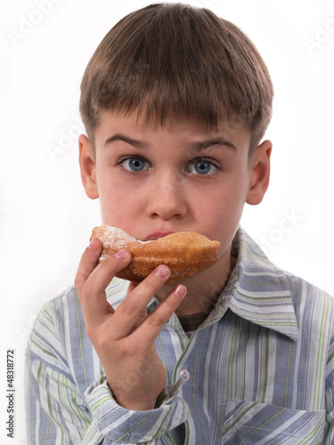 young boy eating donut