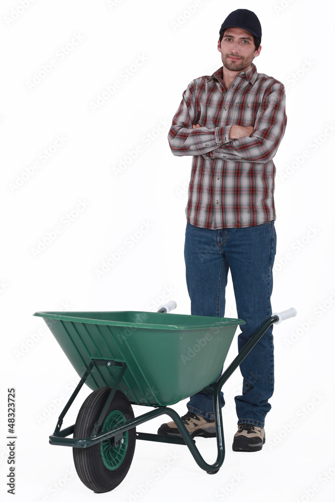 Tradesman standing behind a wheelbarrow Tradesman standing behind a wheelbarrow