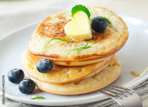 Stack of blinis or pancakes with blueberries