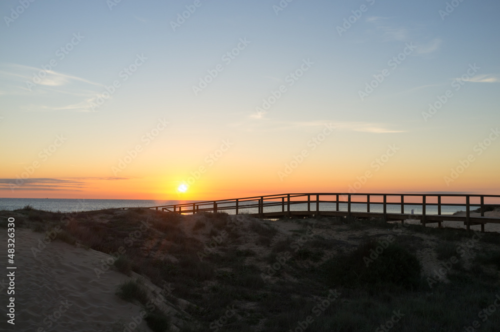 Sunrise over coastal dunes