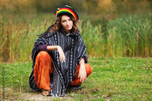 Young rastafarian woman in autumn park photo