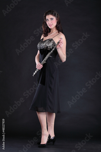 elegant woman and flute on a black background