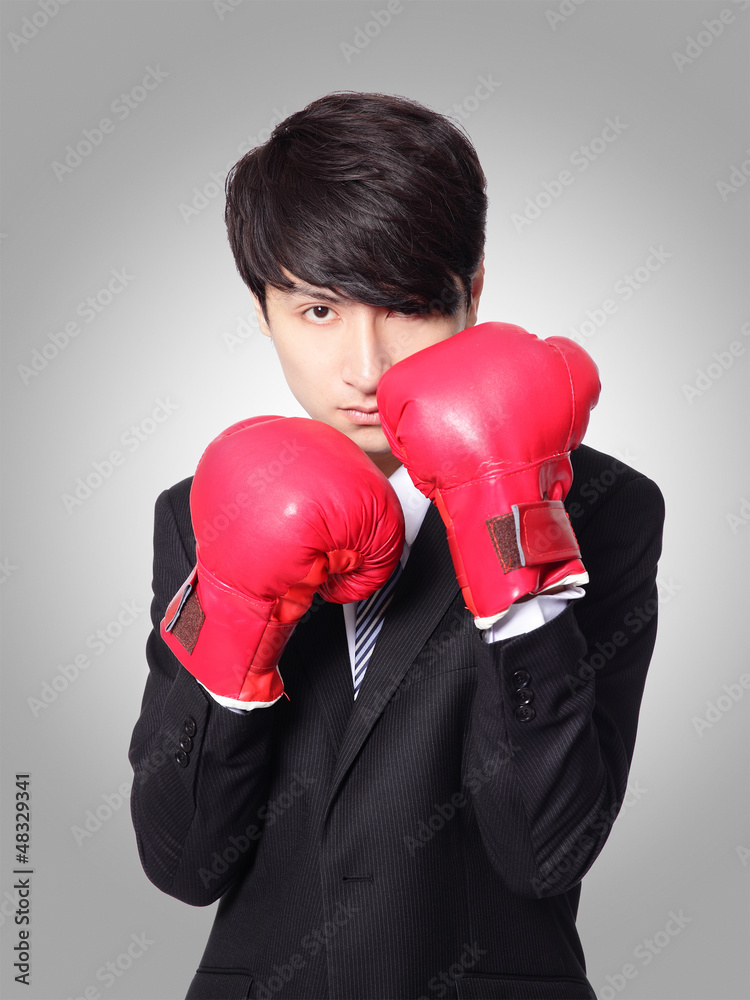 businessman ready punching with boxing gloves businessman ready punching with boxing gloves