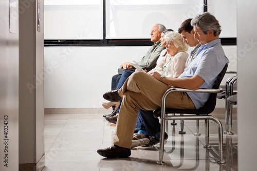 People Waiting For Doctor In Hospital Lobby photo