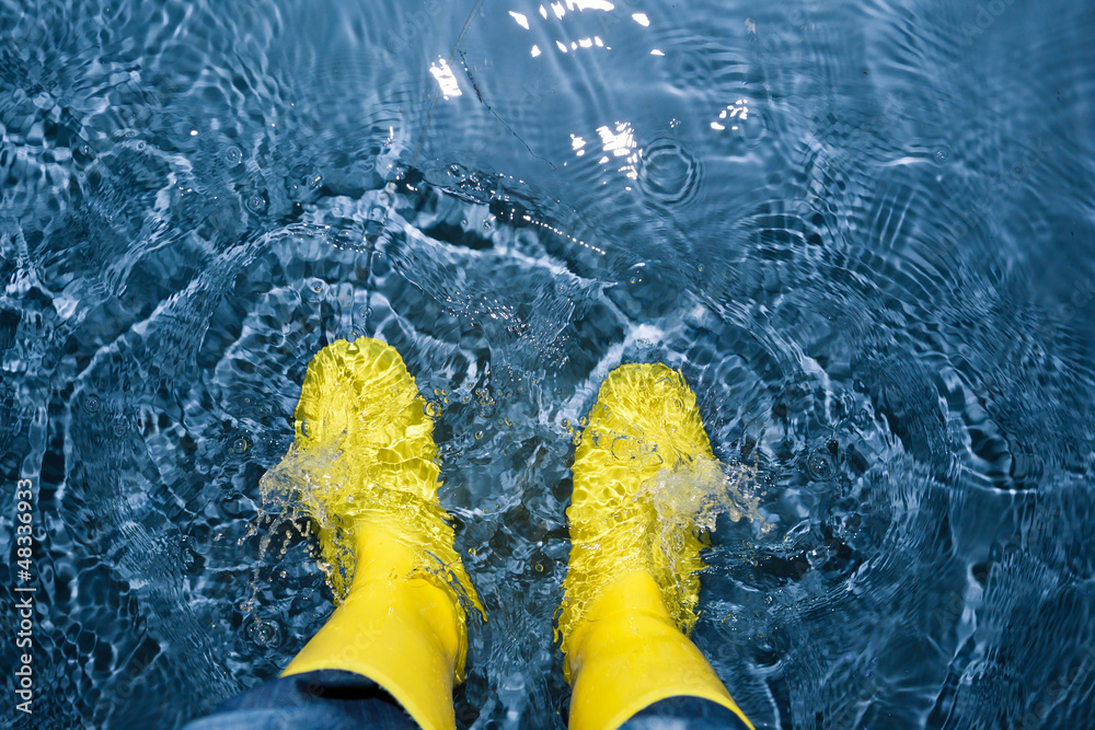 rubber boots splashing in the water - obrazy, fototapety, plakaty 