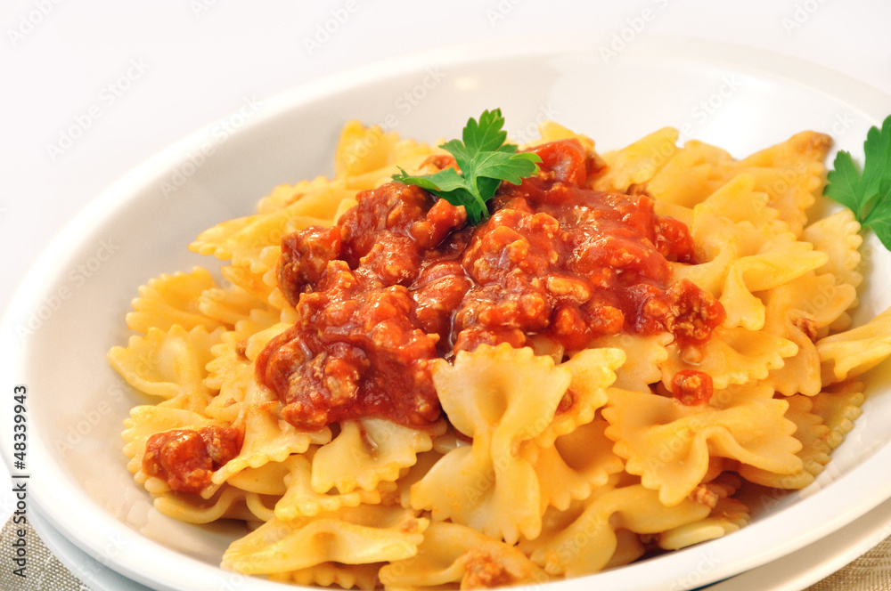 italian pasta - farfalle with meat and tomato sauce italian pasta - farfalle with meat and tomato sauce