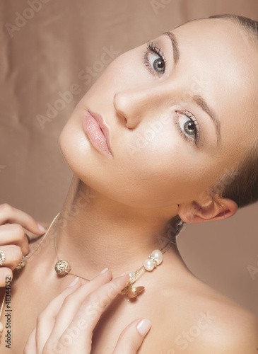 Beauty Woman Face. Elegant Golden Necklace with Pearls