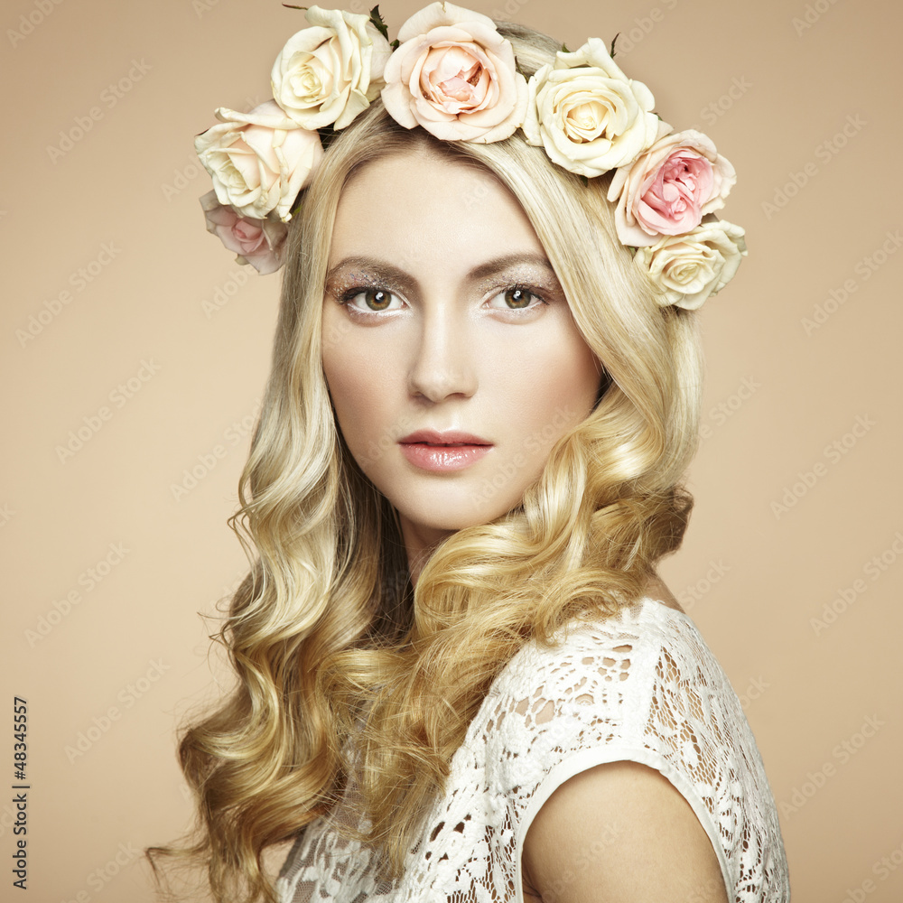 Portrait of a beautiful blonde woman with flowers in her hair