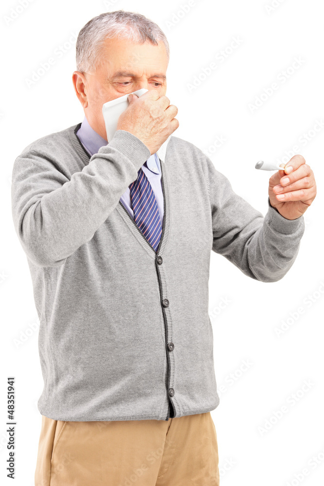 Ill senior man blowing his nose in tissue paper and looking at t Ill senior man blowing his nose in tissue paper and looking at t