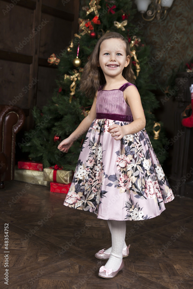 waiting for Santa Claus. Happy little girl near Christmas tree waiting for Santa Claus. Happy little girl near Christmas tree
