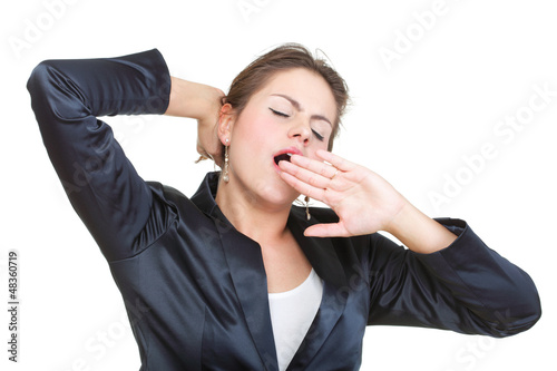 Sleepy business woman yawning and stretching, isolated photo