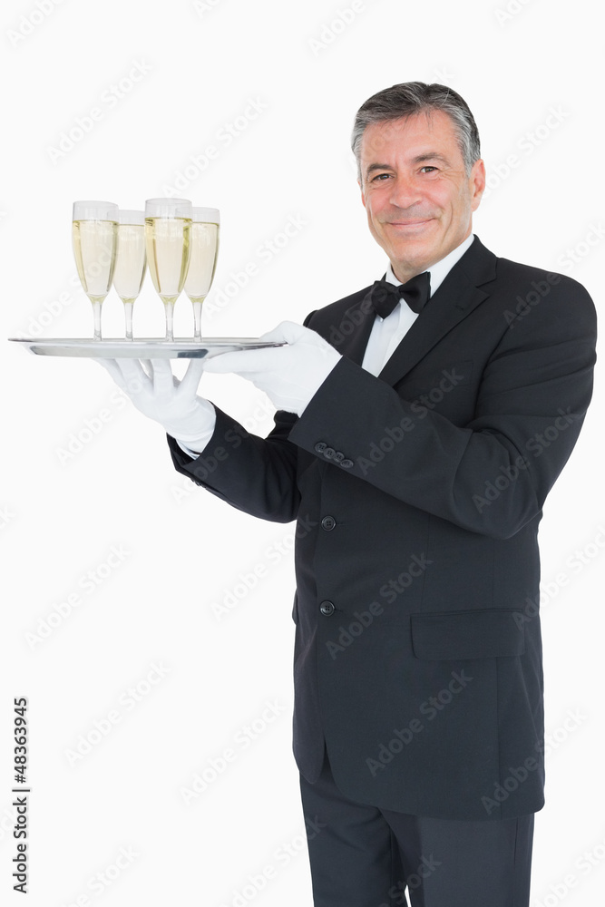 Smiling waiter holding tray with glasses with champagne Smiling waiter holding tray with glasses with champagne