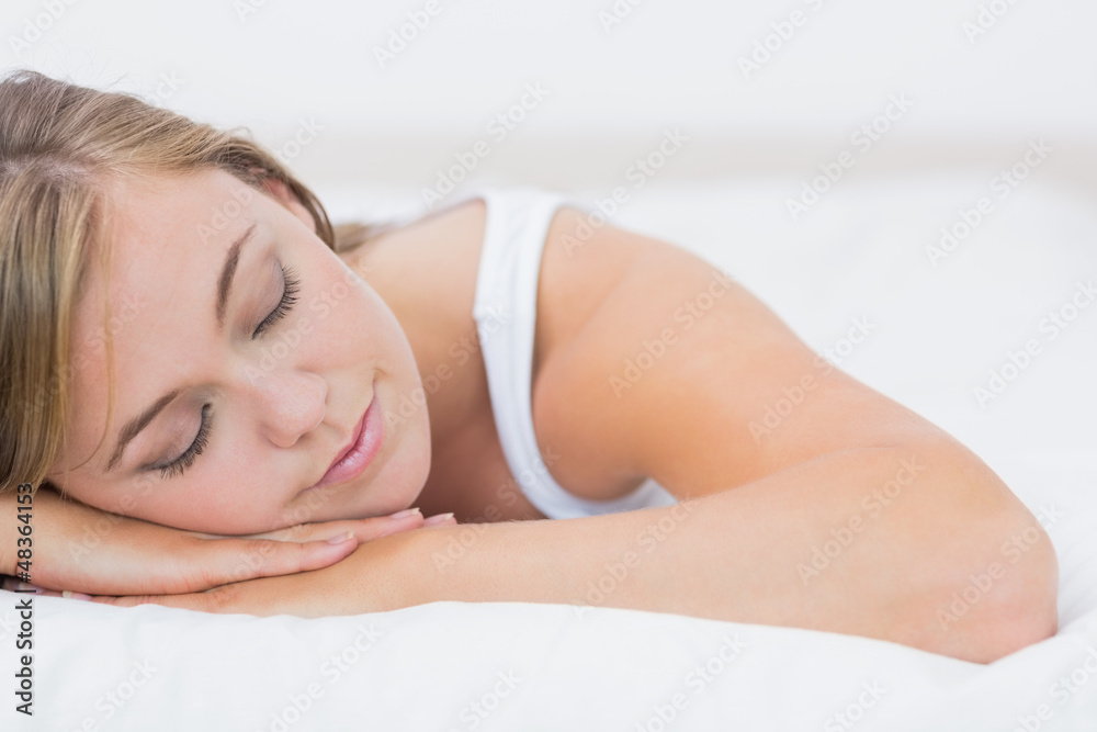 Calm woman napping on the bed