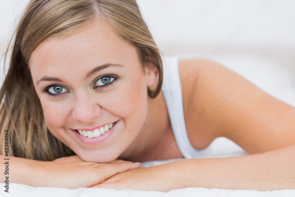Blond woman lying on her bed Blond woman lying on her bed