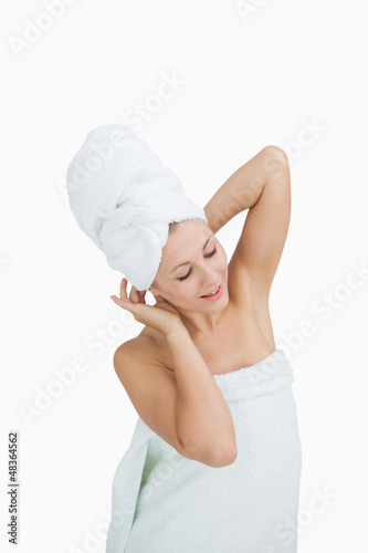 Happy young woman wrapped in towel